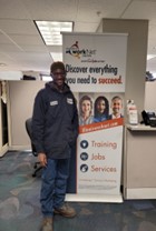 Picture of African-American man wearing blue uniform in a career center office.